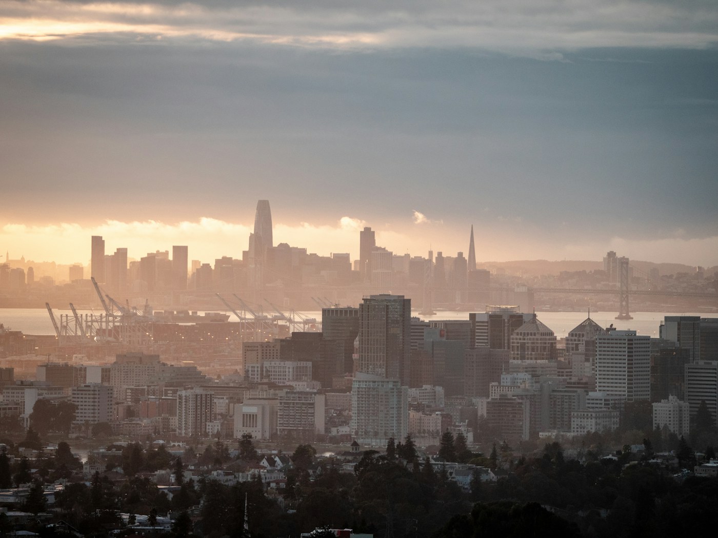 Oakland skyline and San Francisco Bay at sunset, East Bay garage door repair from the flats to the hills