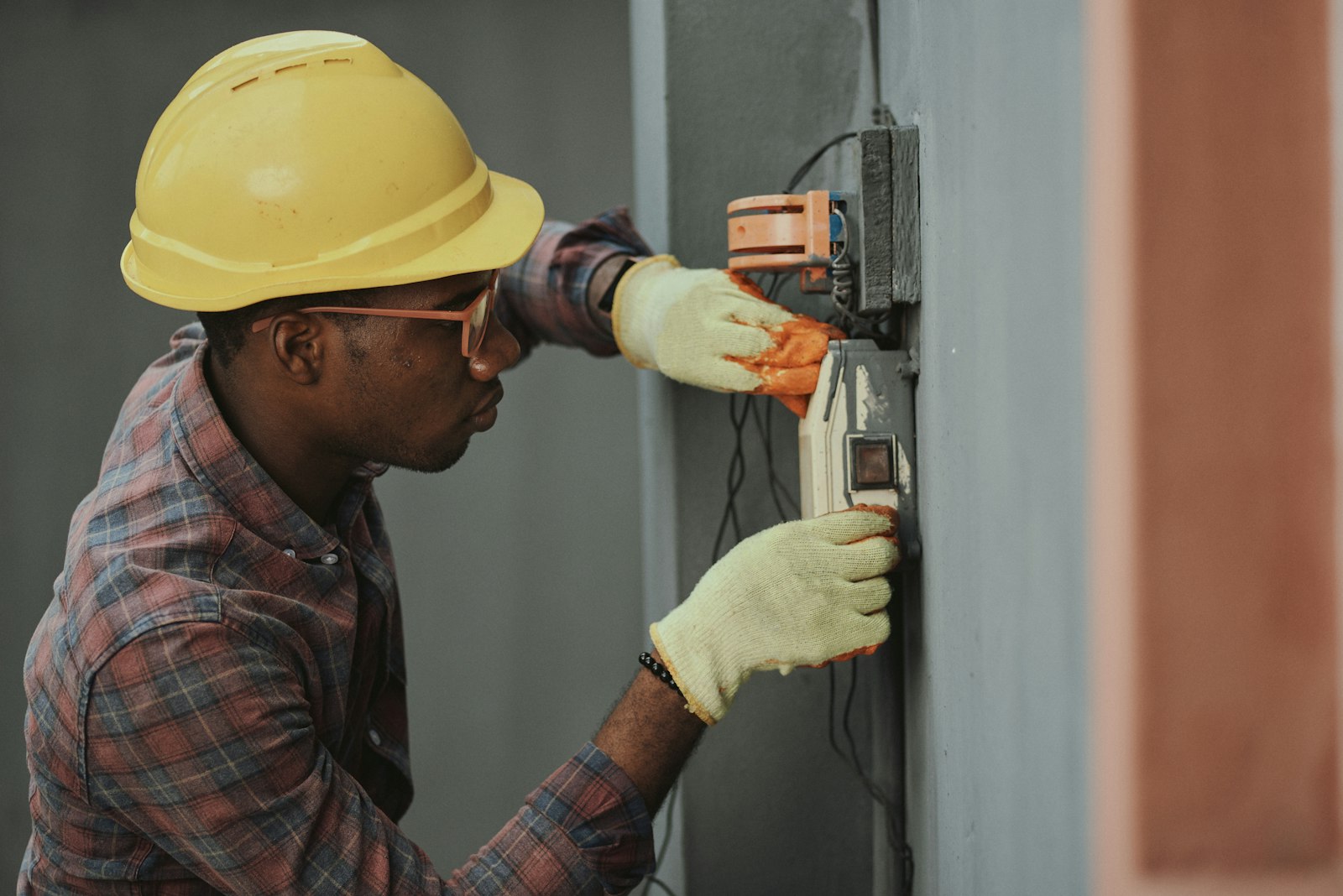 Local technician inspecting door opener wiring during a home service call