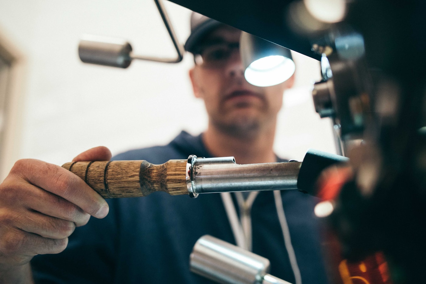 Technician fine-tuning garage door hardware on site. Spring replacement takes precision, not guesswork